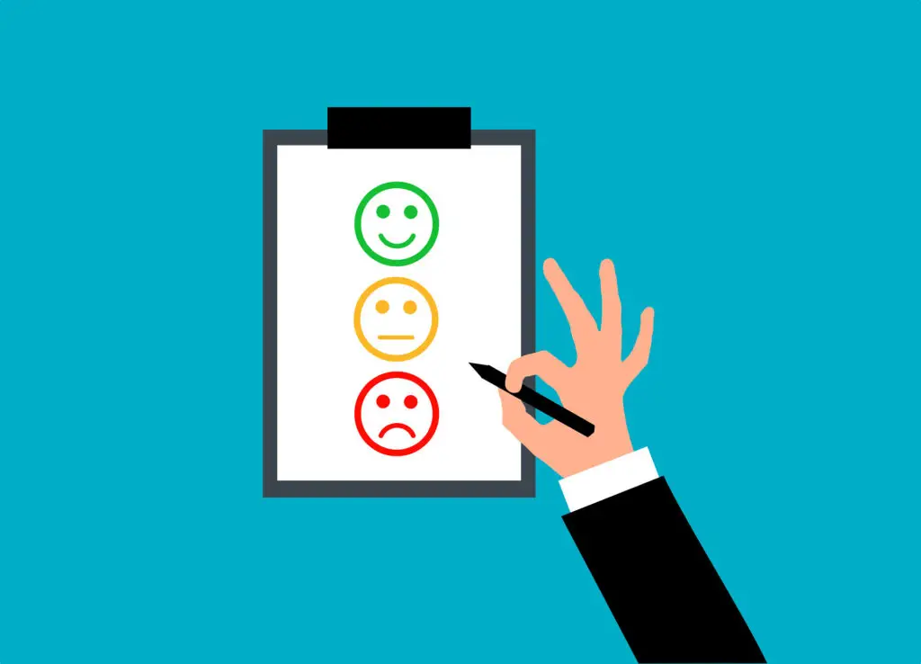 Digital illustration of a hand holding a pen about to choose from three different emotional faces on a clip board