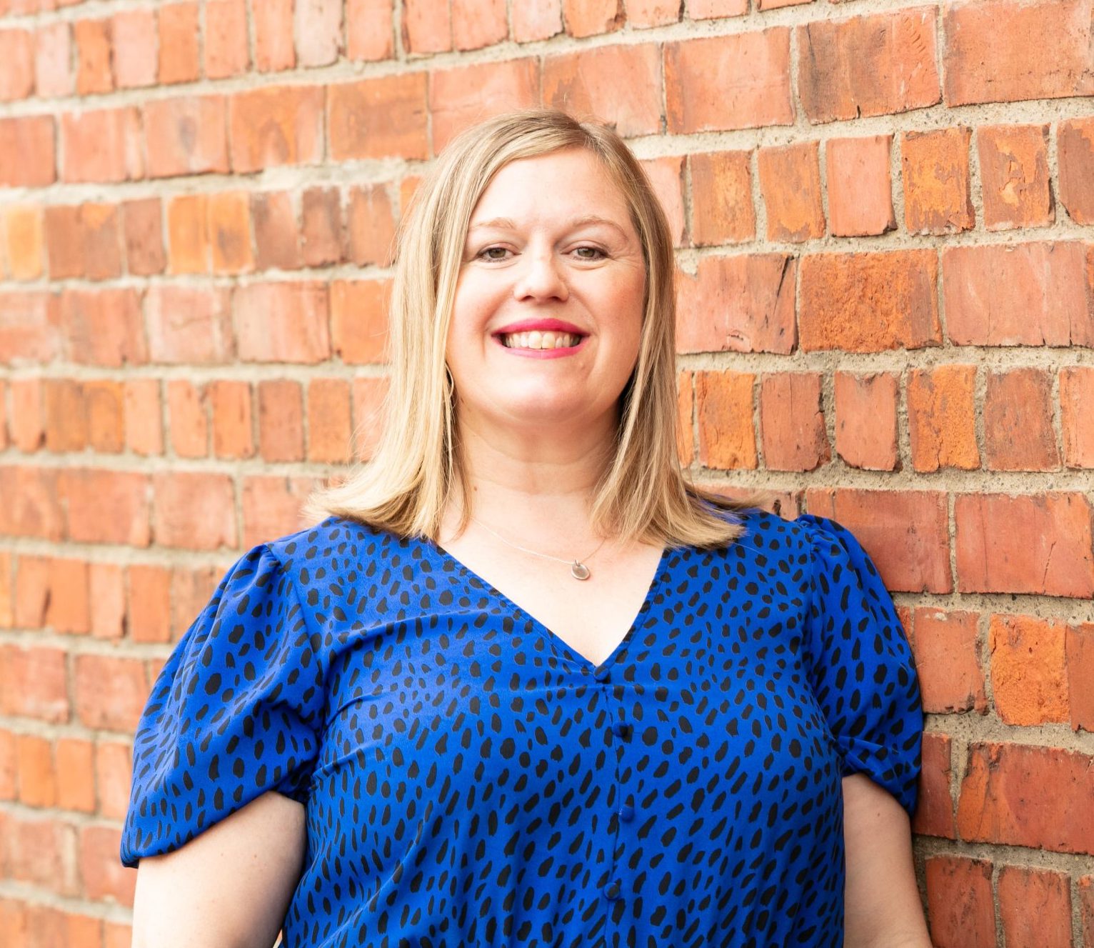 Small, close-crop headshot of smiling team member